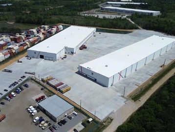 Aerial view of industrial warehouses and storage containers.