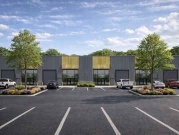 Modern industrial building with parking lot and landscaping.