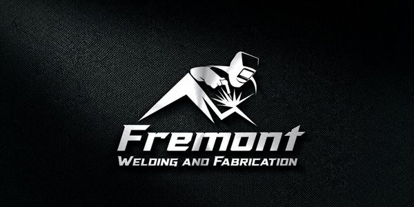 Metallic logo of Fremont Welding and Fabrication with a welder illustration on a textured dark background.