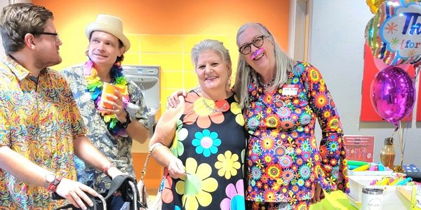 Group in colorful floral clothes at a festive event.