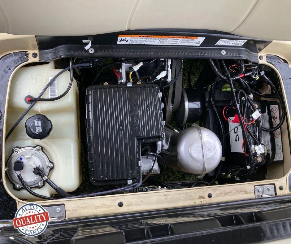 Top view of a golf cart engine and battery compartment.