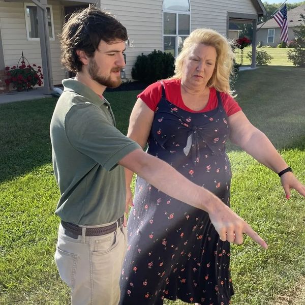 Lux Lawn Care employee speaking with customer about lawn care and mulching in Avon, IN.
