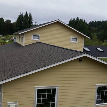 Two-story house with newly replaced architectural shingle roof and new Hardie siding and trim.