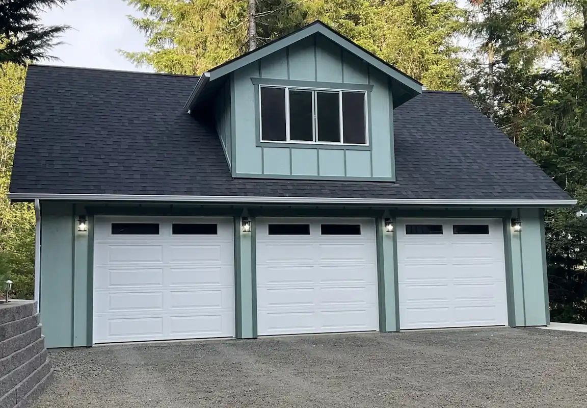 Three-car garage with loft and dormer, wood siding,and asphalt shingle roof built in Chehalis, WA