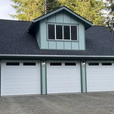 Three-car garage with loft and dormer, wood siding,and asphalt shingle roof built in Chehalis, WA

