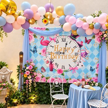 Butterfly-themed baby shower backdrop with a pink, purple and gold balloon garland, an 'A little But