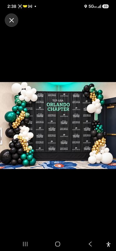 Corporate photo backdrop for the TCF-USA Orlando Chapter with a black step-and-repeat banner framed 
