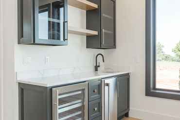 Bar with floating shelves in new construction home that is for sale in Edmond, Oklahoma.