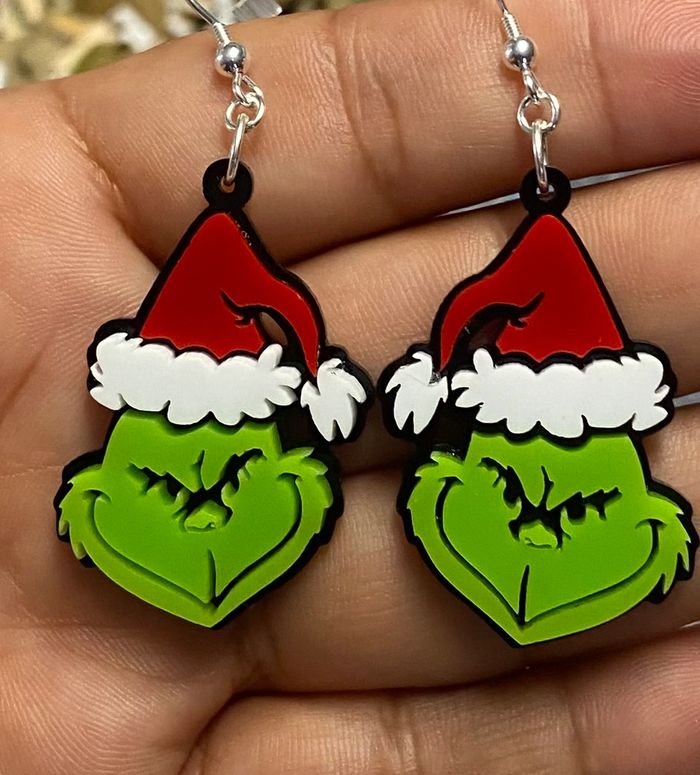 Earrings shaped like the Grinch wearing Santa hats.
