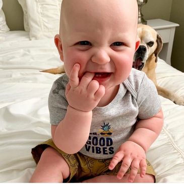 baby boy laughing with dog after a good nap