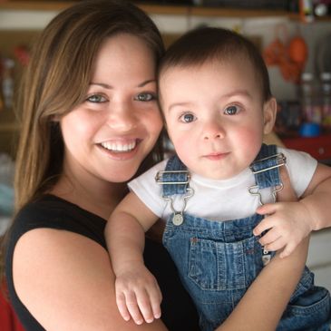 babysitter holding child up for a photo