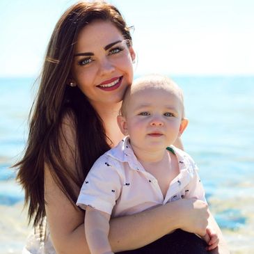 Nanny with toddler at the beach