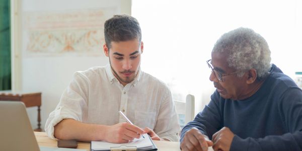 Care worker helping senior with finances