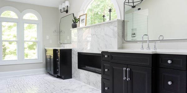 Black and white primary bathroom marble tile fireplace