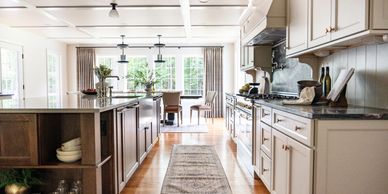 Kitchen addition with custom cabinetry, window treatments and breakfast area furniture.