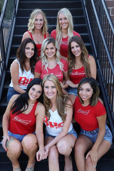 Group of female promotional models in Budweiser shirts on stairs