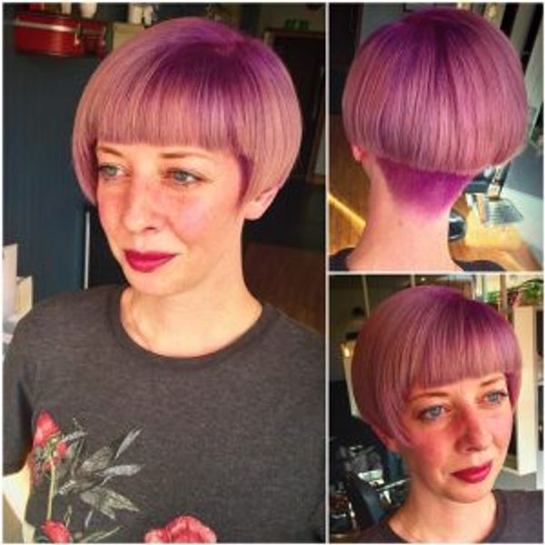 Women with short purple undercut hair.