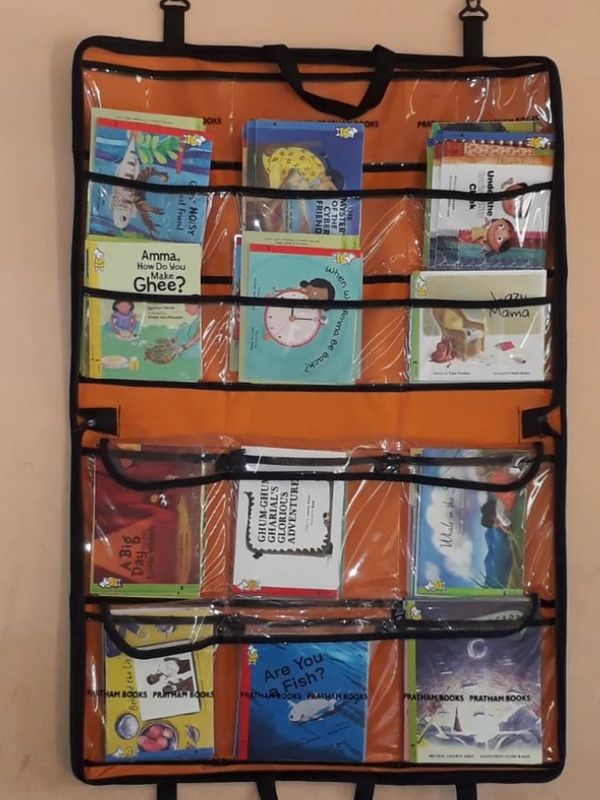 Wall-mounted organizer with children's books.