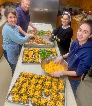 Volunteers cooking 300 meals each week for those in need