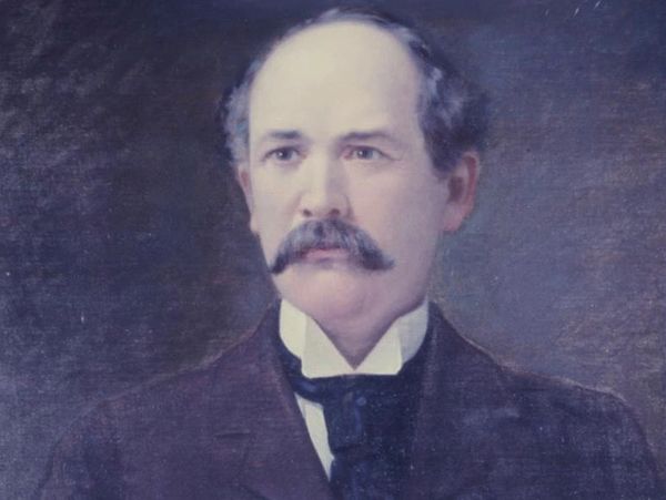 Portrait of a man with a mustache in formal attire.