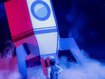 astronaut next to rocket ship