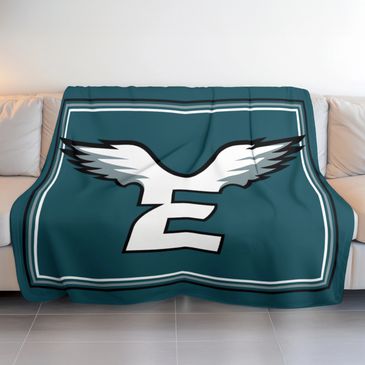 philadelphia eagles midnight green eagles throw blanket thrown over a tan leather couch