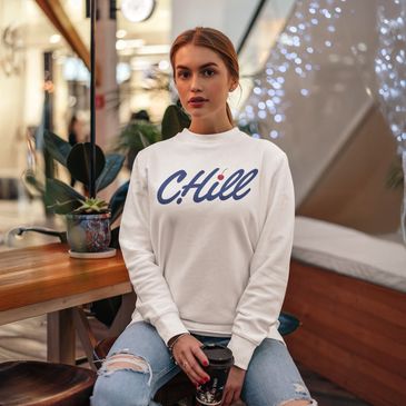 young woman in cherry hill mall wearing a white sweatshirt with CHill on it for new jersey natives