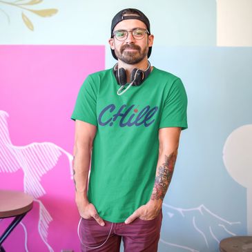 Man with bear and headphones wearing a green t-shirt that has the word Chill on it for Cherry Hill