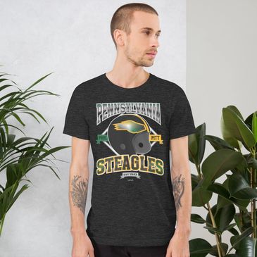 man wearing a pennsylvania steagles t shirt with tattoos