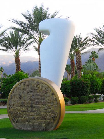 Large white sculpture by disk.