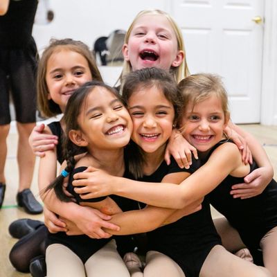 Students in class embrasing with smiles on their faces