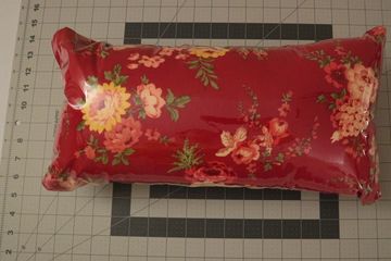 Pillow is encased in clear vinyl so it can be sanitized after use. 