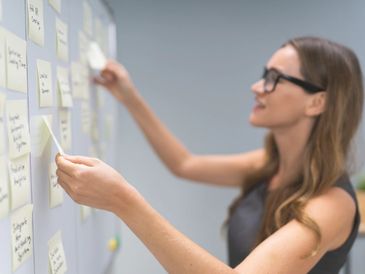 Photo of woman developing a strategy with post-it notes