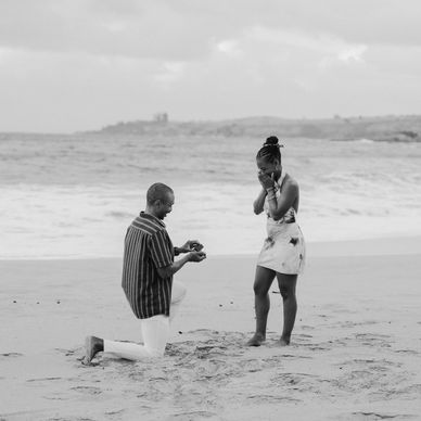 Man proposes to woman on the beach.