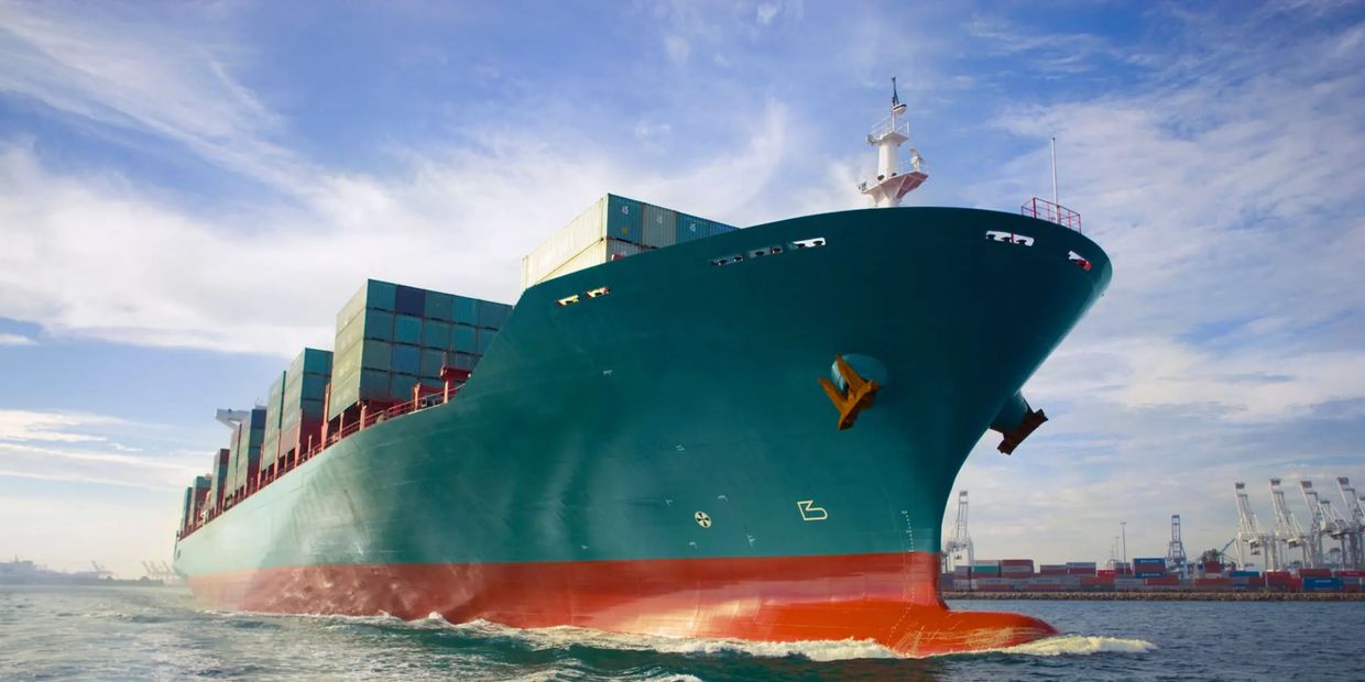 Large cargo ship loaded with containers on the water.