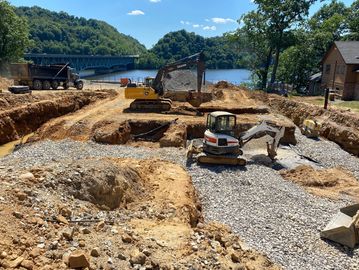 john deere excavator and bobcat mini excavator doing a foundation dig out