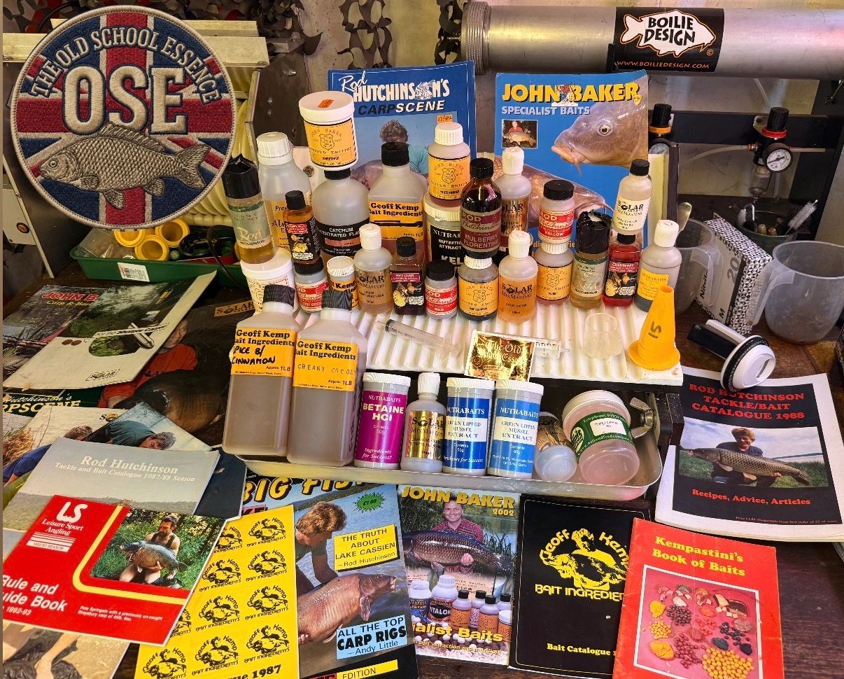 Fishing bait bottles and fishing catalogs arranged on a table.