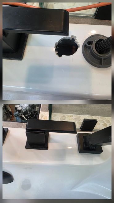 Black faucet set on a white sink with a missing piece around the faucet base.