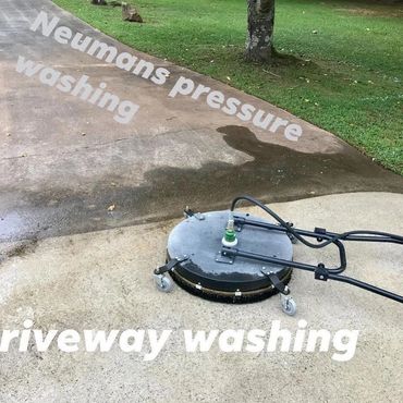 Professional driveway pressure washing in progress.