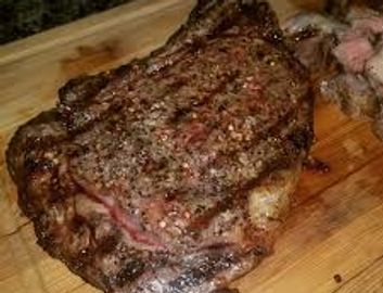 A scenic landscape featuring mountains, a lake, and a clear blue sky.