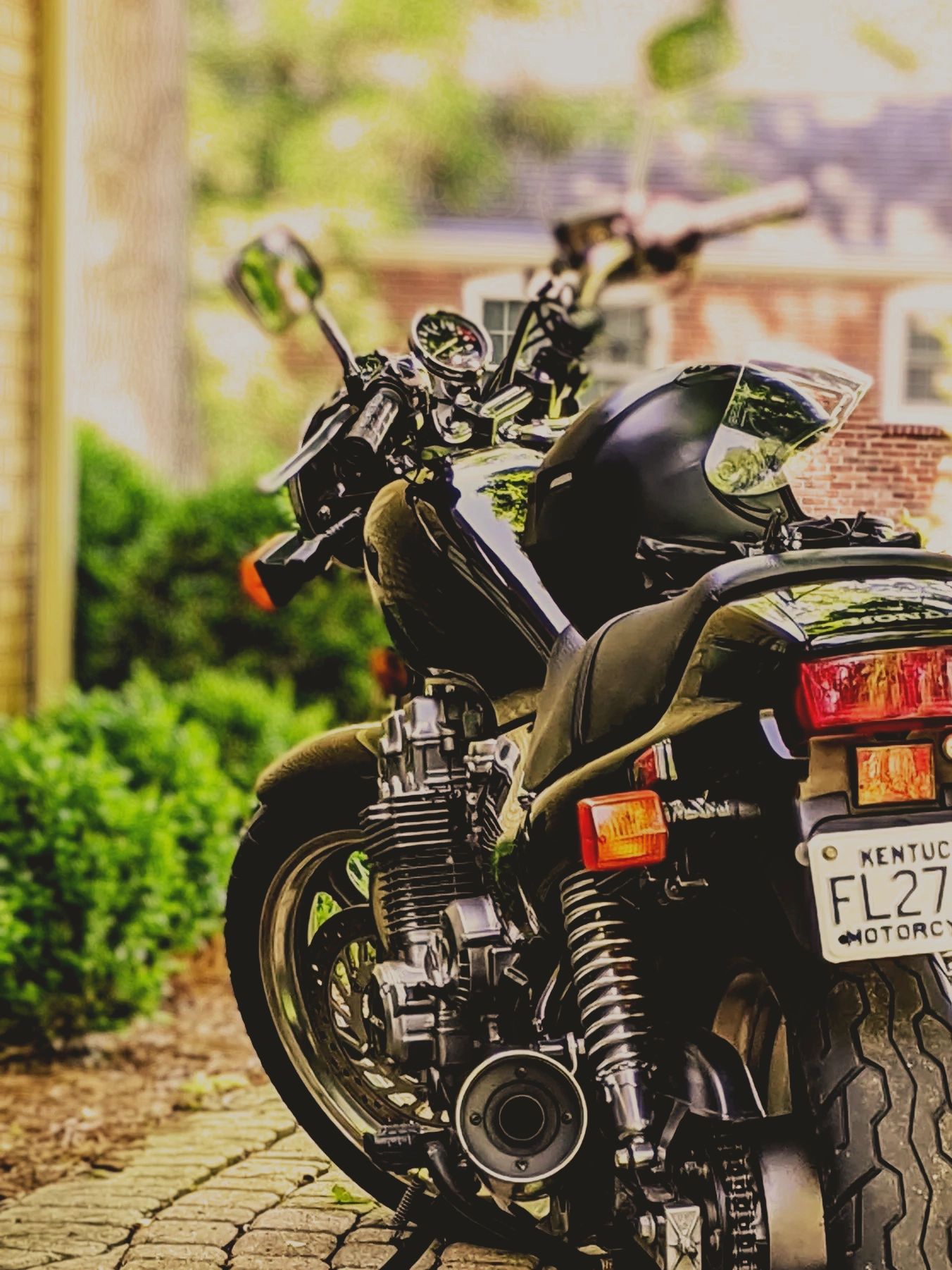 Sleek black Honda motorcycle with Kentucky license plate.