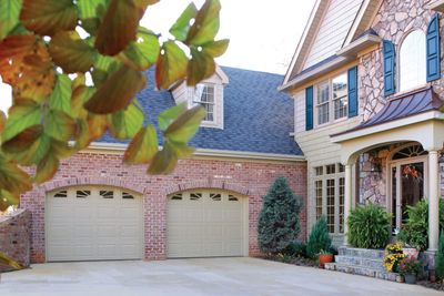 Traditional short panel garage door with windows.