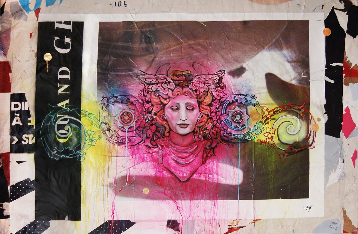 Colorful street art of a winged female head with floral elements.