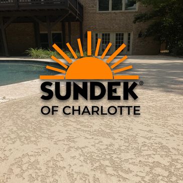 Textured concrete pool deck with Sundek of Charlotte logo overlay.