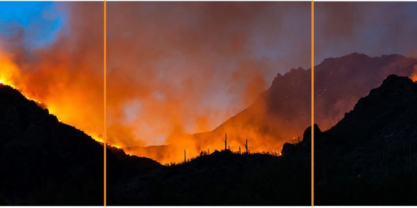 Wildfire burning across a mountain ridge