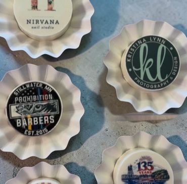 Unique fluted ceramic dishes featuring various business logos and designs.