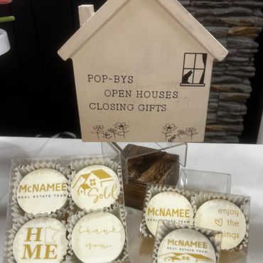 Decorative house sign with promotional cookies for McNamee Real Estate Team.