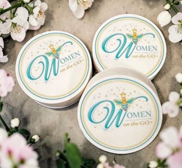 Three circular badges with 'Women on the GO' text surrounded by flowers.