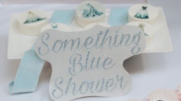 Decorative sign reading 'Something Blue Shower' with matching blue-themed items.