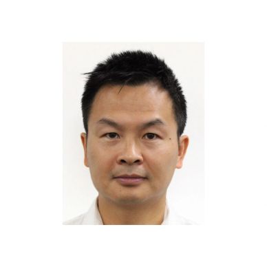 Portrait of a man with short black hair.